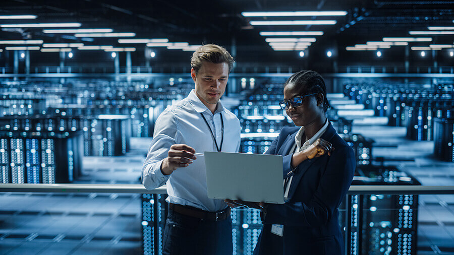 Woman And Man Analysing Data In Data Center