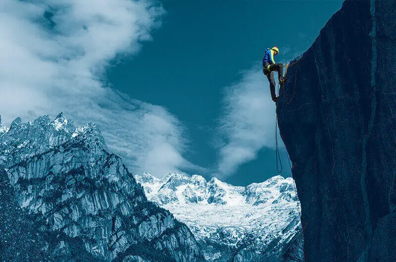 Climbers abseiling against a mountain backdrop. Alert and Mobilise with FACT24