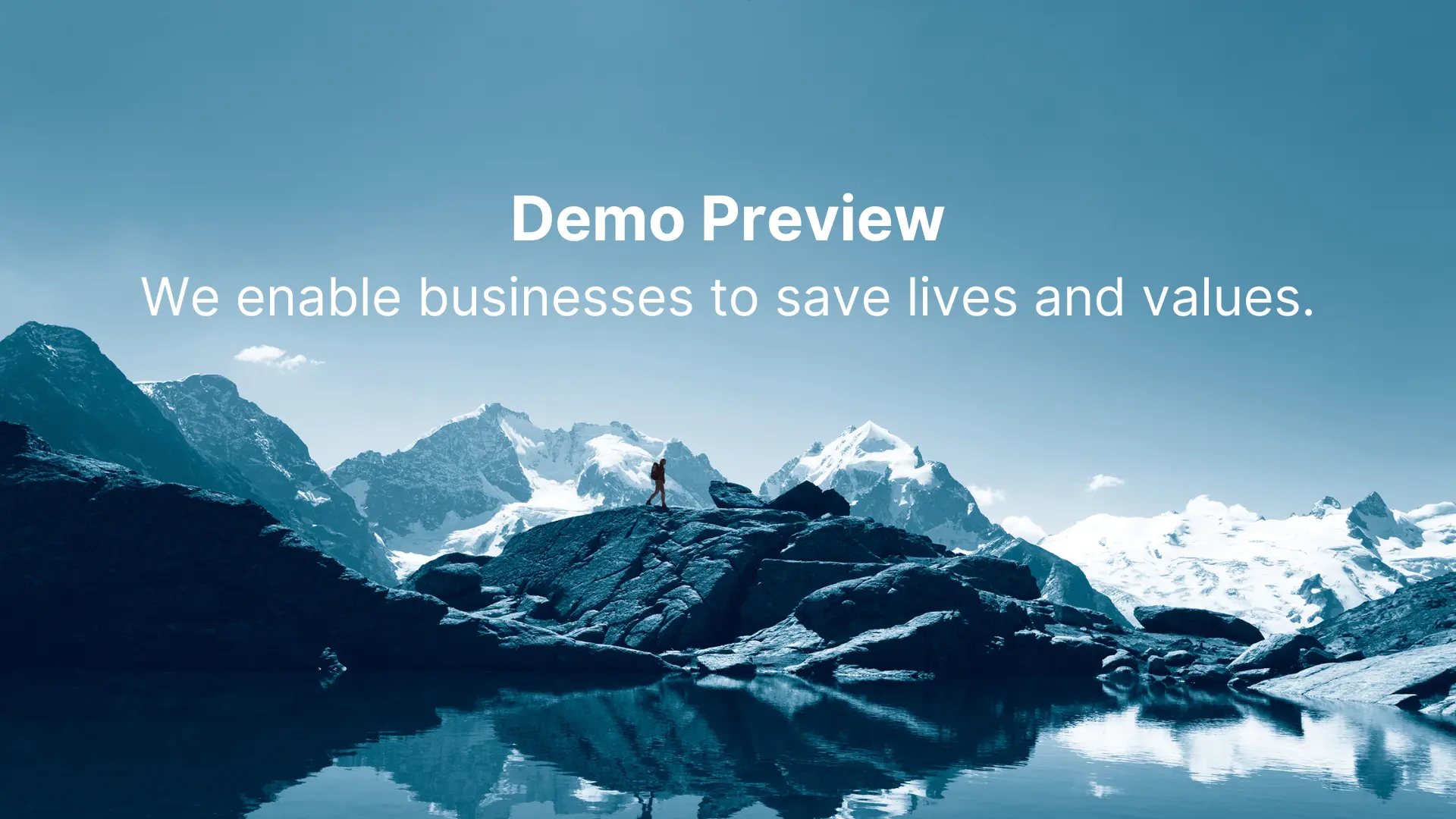 A person stands on rocky terrain by a calm lake, with snow-capped mountains in the background. The text reads: "Demo Preview - We enable businesses to save lives and values, even amidst supply chain challenges." The scene is in a cool blue tone.