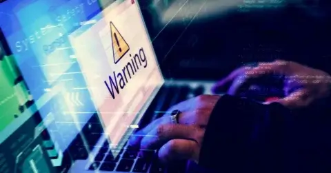 A person typing on a laptop displays a warning message with a triangular caution symbol, signaling the urgency of a crisis plan. The background features digital and code-like graphics, enhancing the high-tech ambiance of the scene.