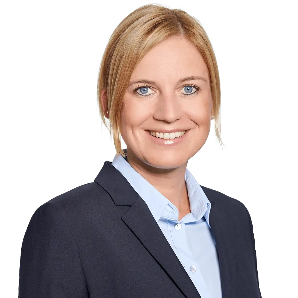 A woman with blonde hair in a neat bob, wearing a dark blazer and light blue collared shirt, smiles at the camera against a plain white background—ideal for use as F24 press contact and photo materials.