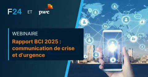 A promotional image for a webinar hosted by F24 and PWC features text: "Webinaire: Rapport BCI 2025 - communication de crise et d’urgence." A hand holds a smartphone with a city skyline and digital icons in the background, highlighting the theme of strategic crisis management.