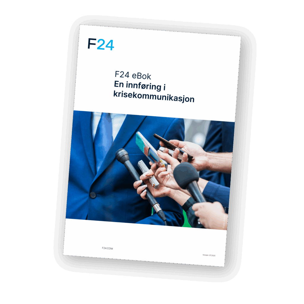 Cover of an eBook titled "F24 eBok En innføring i krisekommunikasjon" showing several microphones and recording devices held up to a person in a blue suit during a press interview.