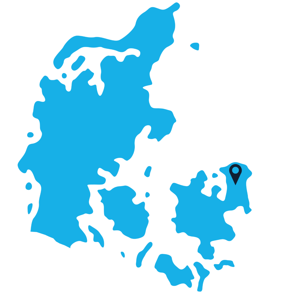 A simplified blue map of Denmark on a light blue background, with a location pin marking a spot on the eastern side of the country.