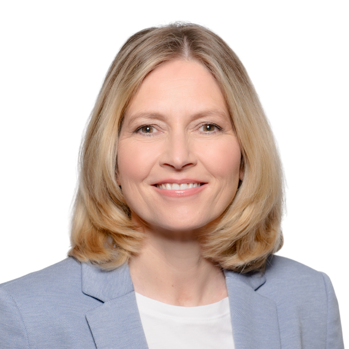 A woman with shoulder-length blonde hair, wearing a light blue blazer over a white top, smiling at the camera against a plain background.