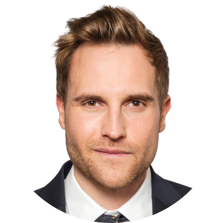Portrait of a man with light brown hair, trimmed beard, and light skin, wearing a dark suit and tie. He looks directly at the camera against a plain white background, ready to host the upcoming Webinar PWC & F24.