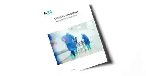 Cover of a report titled "Cliniques et hôpitaux: Alerte et gestion de crise" showing medical staff in blue scrubs quickly wheeling a patient on a stretcher down a hospital corridor.