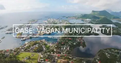 Aerial view of a coastal town with houses, water, islands, and surrounding mountains under a partly cloudy sky. Text overlay reads: "CASE: VÅGAN MUNICIPALITY.