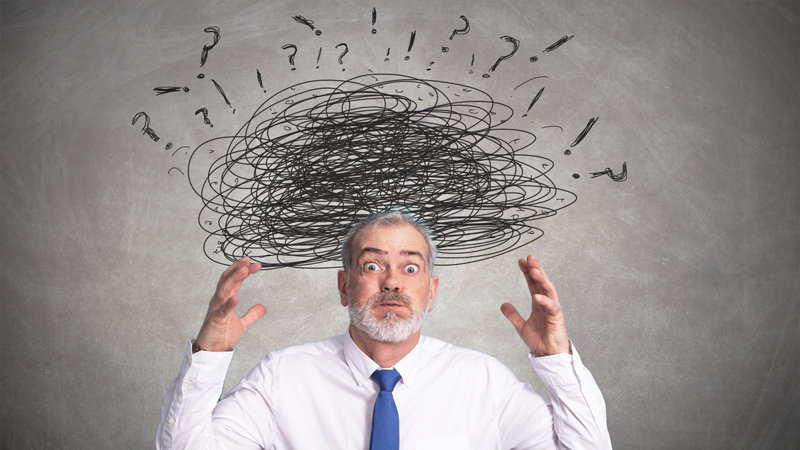 A man appearing overwhelmed by krisehåndtering, with a chaotic scribble and question marks floating above his head.